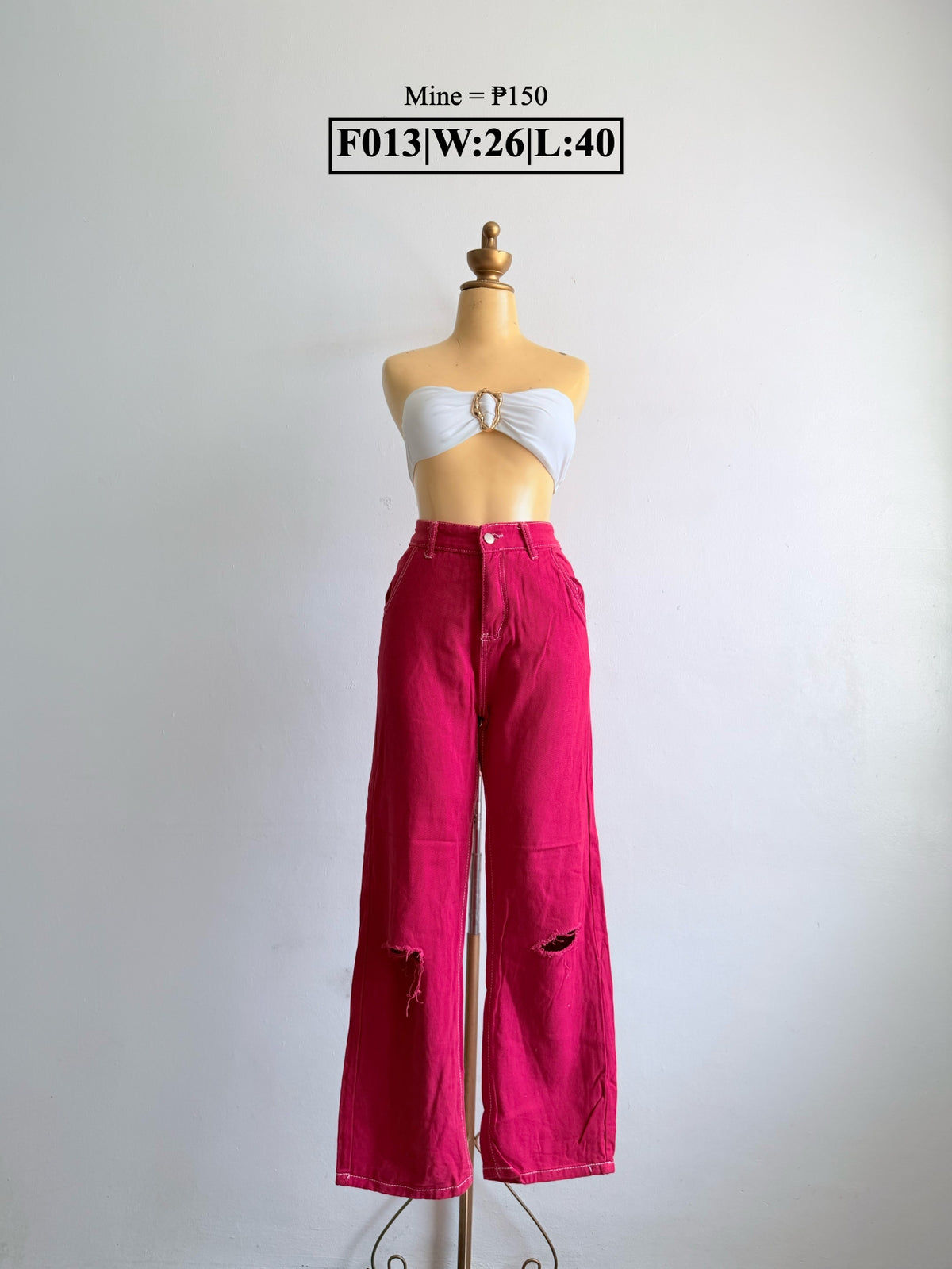 Bright pink wide-leg pants with ripped detailing at both knees