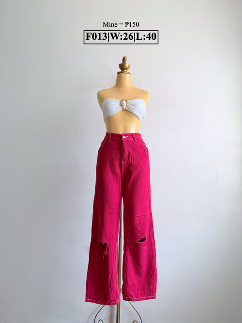 Bright pink wide-leg pants with ripped detailing at both knees
