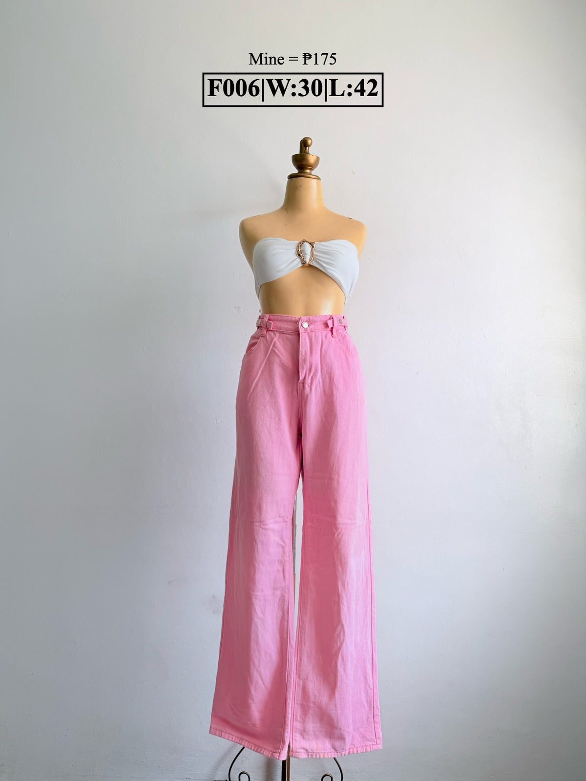 Pink wide-leg pants with button-front waistband on a mannequin